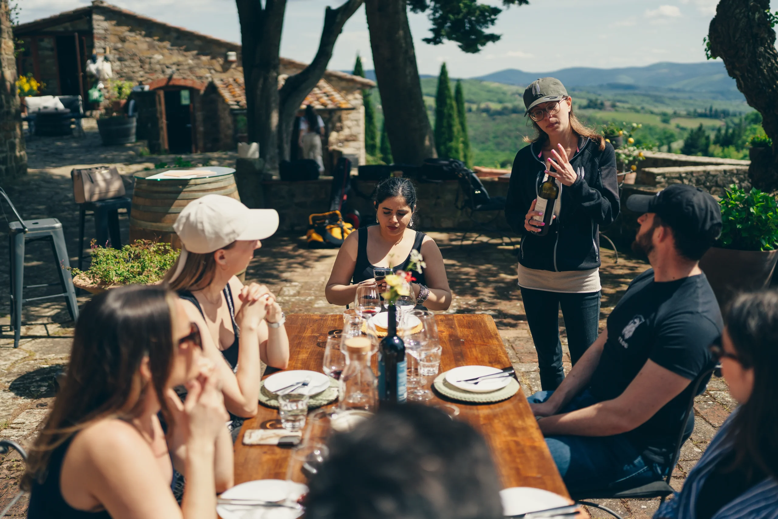 people sit down at the table listening the sommelier
