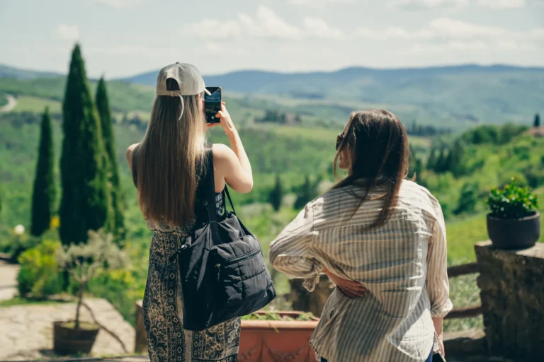 Guests photographing the Chianti hills from a winery terrace