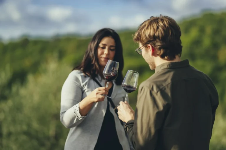 Couple tasting red wine outdoors in Chianti