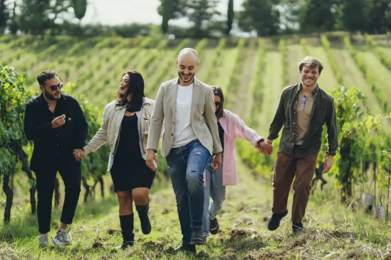 Guests walking through a Chianti vineyard with a local sommelier